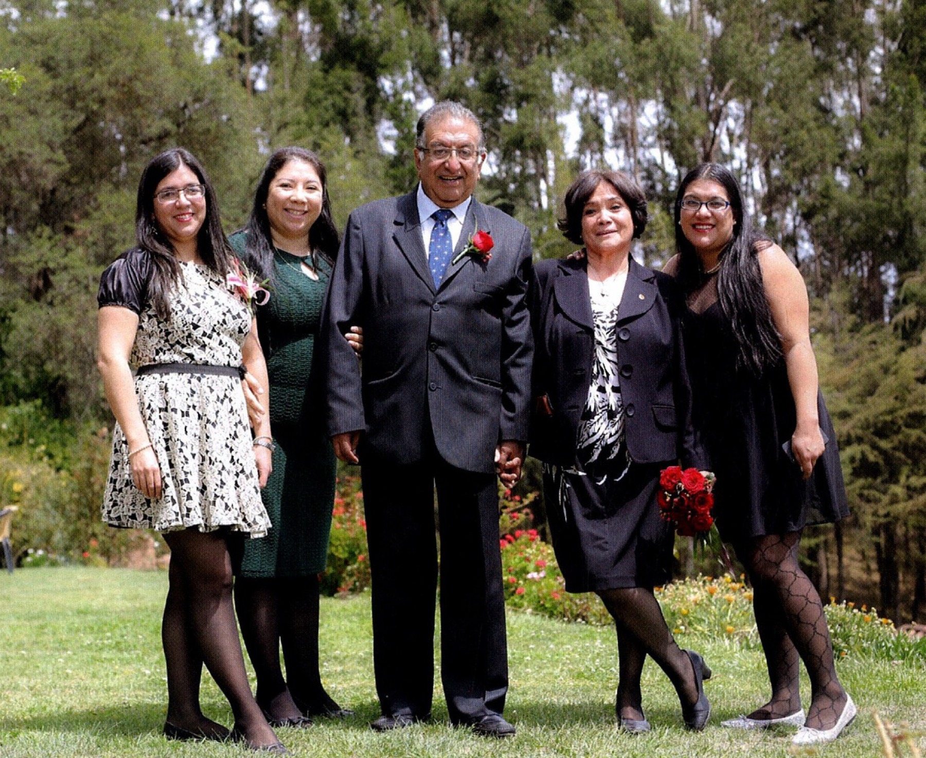 Carlos Milla Vidal with his wife and three daughters in a garden